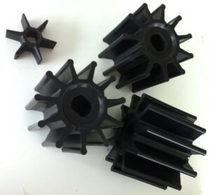 Large rubber impellers for dairy or marine pumps, various sizes, black flexible vanes with central shaft hole, used in fluid handling and CIP systems.