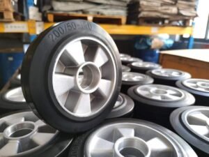 Rubber wheels with aluminum cores, 200/50-140 size, stacked in factory storage, designed for industrial carts and heavy-duty mobility.