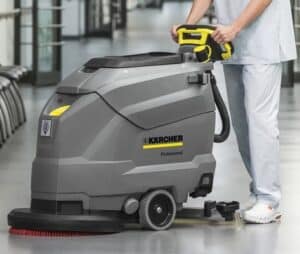 Non-marking rubber wheels on a floor scrubber machine ensuring pristine floors in high-traffic environments, alongside stacked industrial non-marking wheels for various applications.