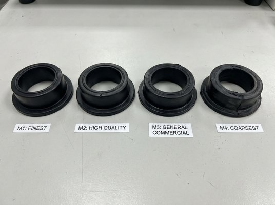 ISO 3302-1 tolerance class comparison, showing M1, M2, M3, and M4 molded rubber parts from finest to coarsest quality