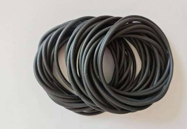 Silicone sponge gaskets coiled on white background, showing flexible round cross-section and soft compressible texture for sealing applications.