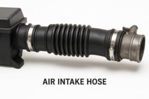 Automotive air intake hose, black rubber corrugated tube with metal clamps, connected to engine and air filter box, labeled for identification.