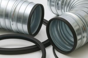 Rubber gasket seals on galvanized HVAC duct connectors, close-up showing installation detail and sealing rings for air-tight connections.