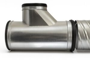 Self-sealing EPDM gasket installed in galvanized steel duct T-joint, airtight HVAC connection for spiral vent systems, shown on white background.