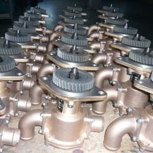 Seawater rubber impeller pumps, bronze body with gear drive, multiple assembled units arranged on workshop floor, marine engine cooling application.