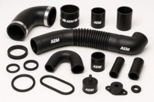 AEM rubber components set, black AEM hoses, sleeves and O-rings, displayed on white background for automotive sealing uses.