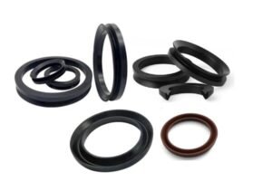 Assorted rubber V-ring seals in black and brown, displayed on a white background, showing various sizes and lip profiles for rotating shaft sealing and dust exclusion.