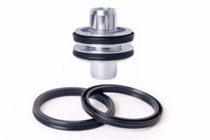 Hydraulic piston assembly with black rubber lip seals, showing two sealing rings for high-pressure applications in cylinders and machinery.