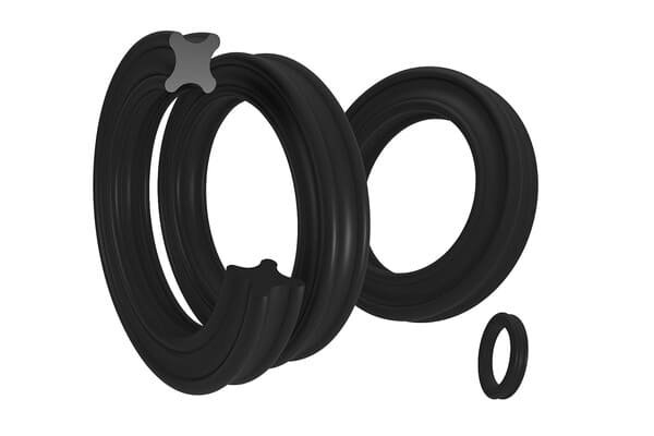 Exploded view of black quad ring seal with visible X-shaped cross-section, showing multiple sealing lips for enhanced leak prevention in hydraulic or pneumatic applications.