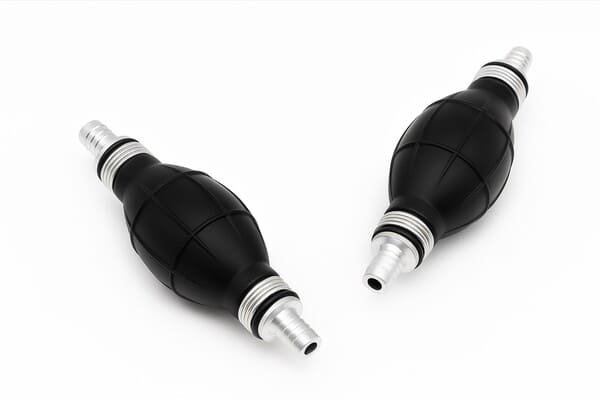 Black rubber fuel primer bulbs with aluminum hose fittings, marine and outboard engine fuel transfer pump accessories, isolated on white background.