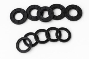Rubber oil seals, black circular lip seals for machinery shafts, designed to prevent lubricant leakage and block dust and contaminants.