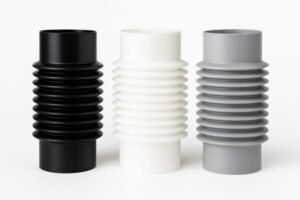 Black, white, and gray silicone rubber bellows with corrugated design, used for flexible sealing and protection in industrial and automotive applications.