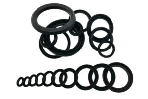Assorted black rubber V-ring seals in various diameters, arranged in circular stacks and a linear size sequence, displayed on a white background for size comparison and selection.