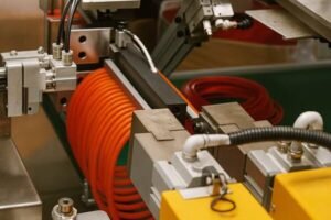 Spliced rings production, automated bonding machine processing orange rubber cord, precision cutting and vulcanizing for custom sealing rings.