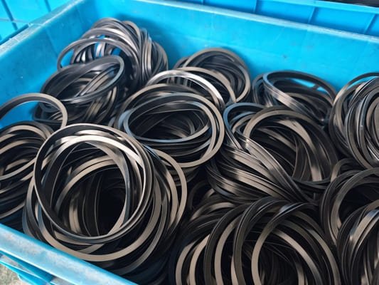 Bulk black rubber sealing rings packed in blue crate